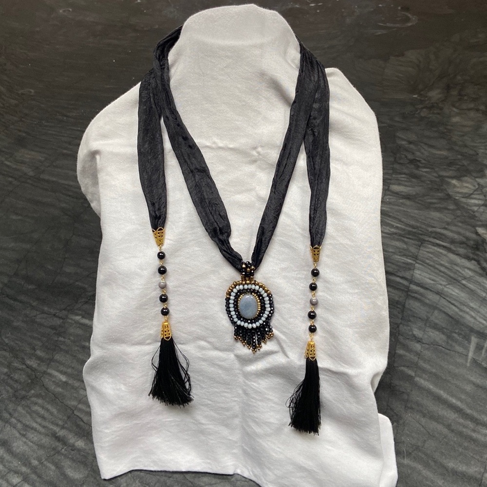 Unique neckpiece, scarf-like and a great substitute for a colorful necklace.